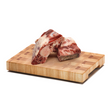 Naked Dog Raw Beef Spare Ribs on a wooden chopping board.