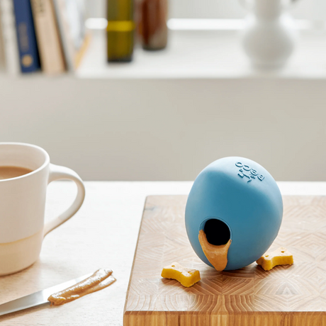 Beco rubber wobble ball with peanut butter oozing from the opening.