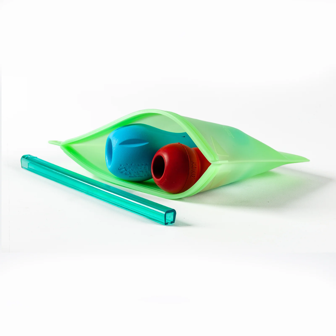 Enrichment dog toys inside a green No Fuss Fill Prep and GO bag. 