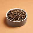 DARF Regular Cold Pressed Dog Food in a white ceramic bowl.