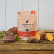 Bag of Innocent Hound Training Treats Tuna and Crab Rewards on a wooden surface, surrounded by raw ingredients and loose treats.