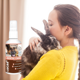 A child holding their pet rabbit, to the left of a bottle of provilan probiotic dental care for pets.